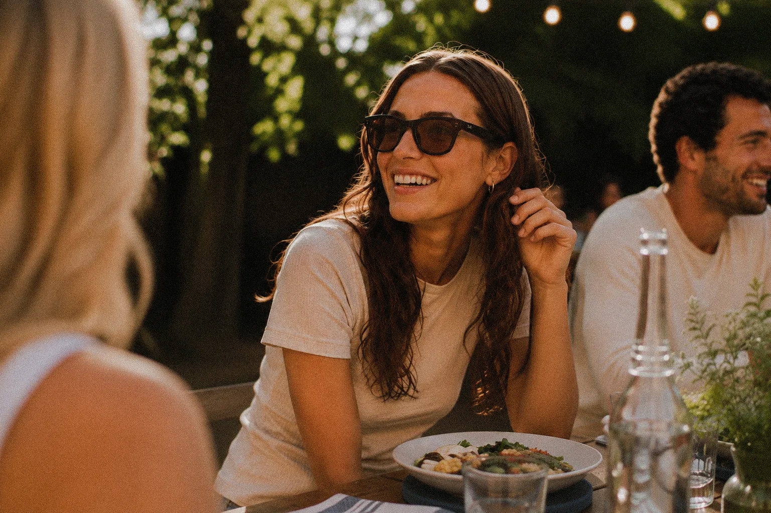 Ray-Ban partner campaign imagery: friends at a golden-hour dinner table, one wearing Ray-Ban sunglasses. AI-generated, art directed by Michael James Clarke