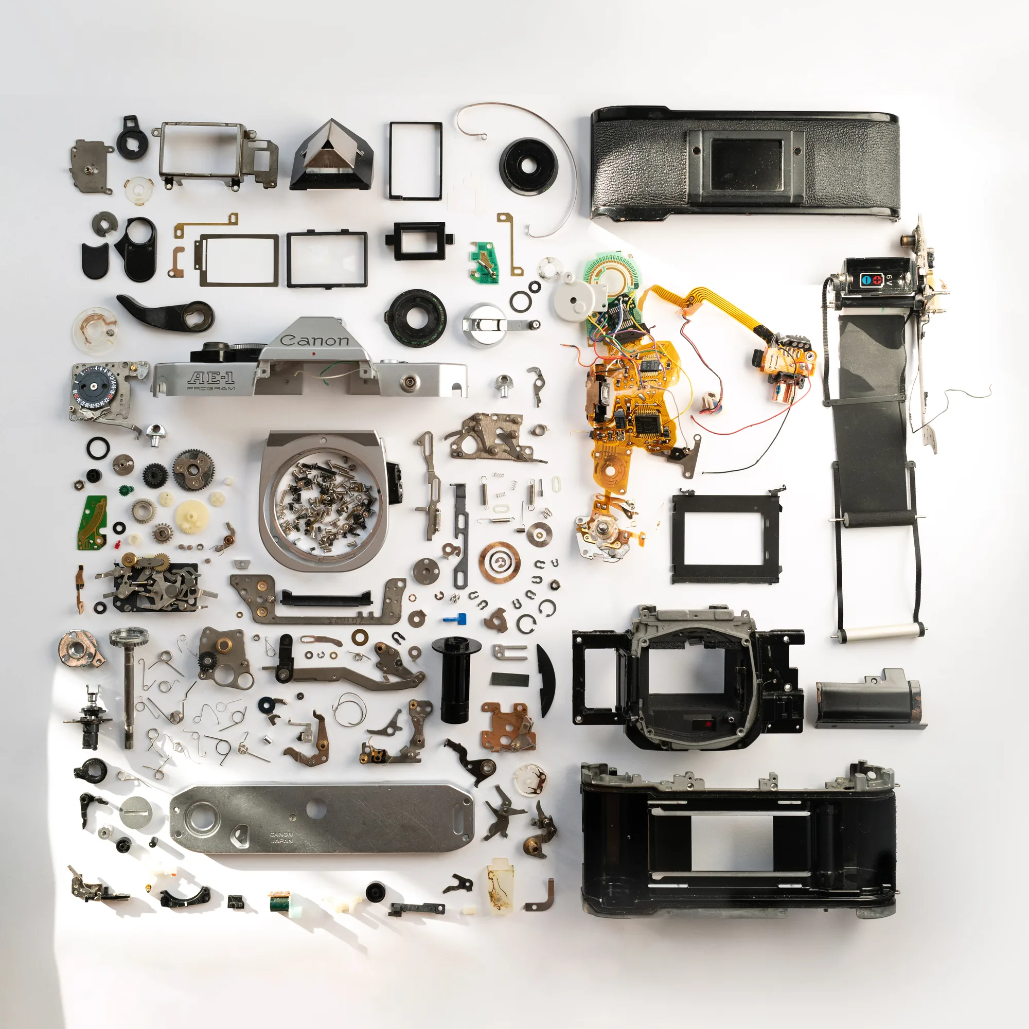 A Canon film camera disassembled and laid out